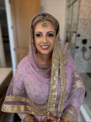 Bride in lavender traditional attire with completed hair and makeup